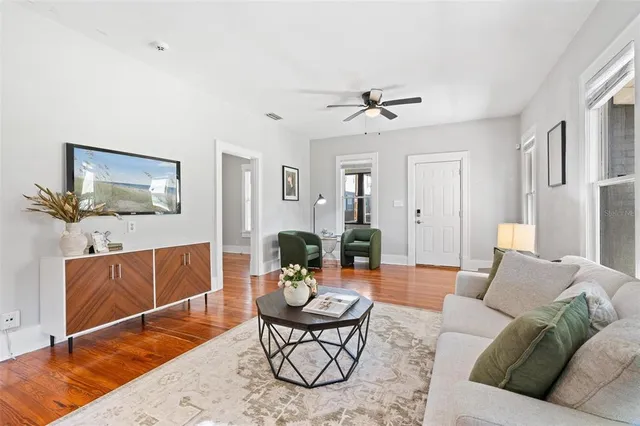 a living room with furniture a rug and a chandelier