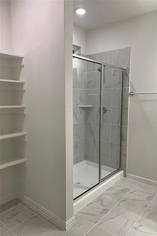 a bathroom with a glass shower door