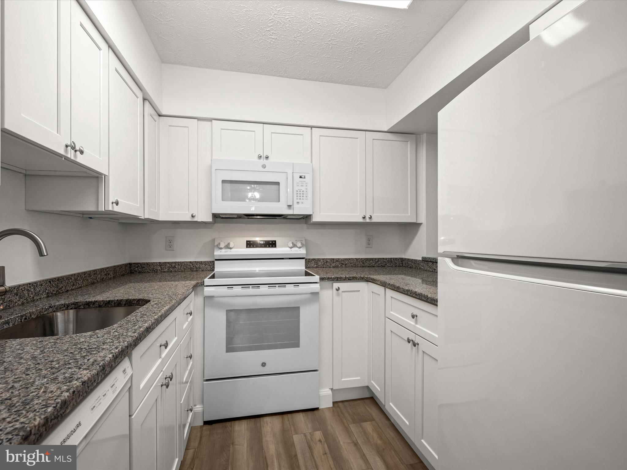 7607 Weather Worn Way, Unit A Columbia, MD 21046 - Photo 15 of 36 a kitchen with cabinets appliances a sink and a counter top space