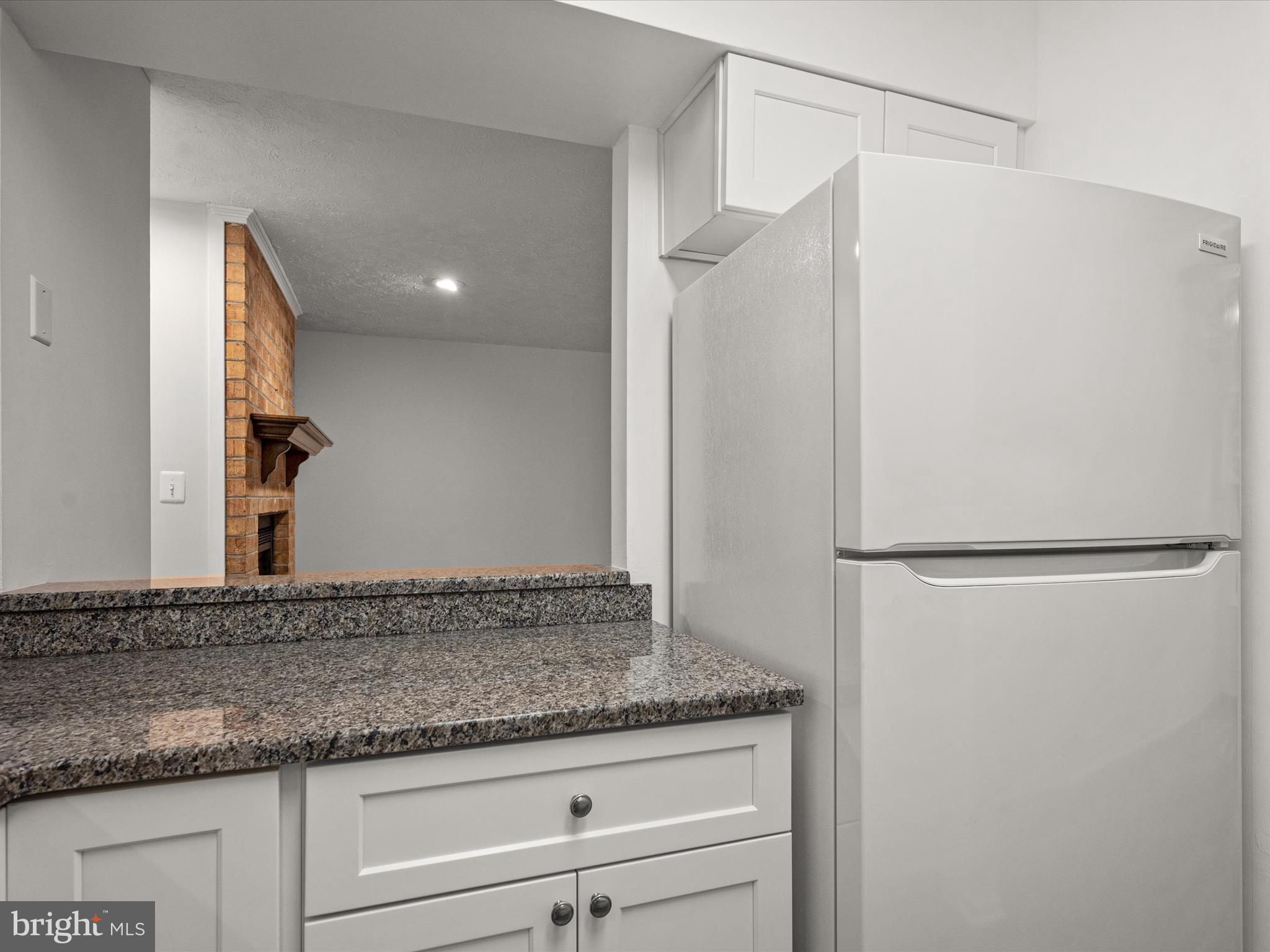 7607 Weather Worn Way, Unit A Columbia, MD 21046 - Photo 19 of 36 a bathroom with a granite countertop shower and a sink