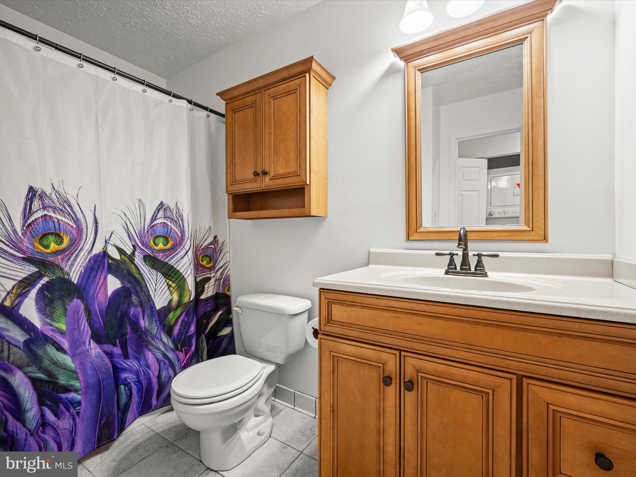 7607 Weather Worn Way, Unit A Columbia, MD 21046 - Photo 29 of 36 a bathroom with a sink a toilet and a mirror