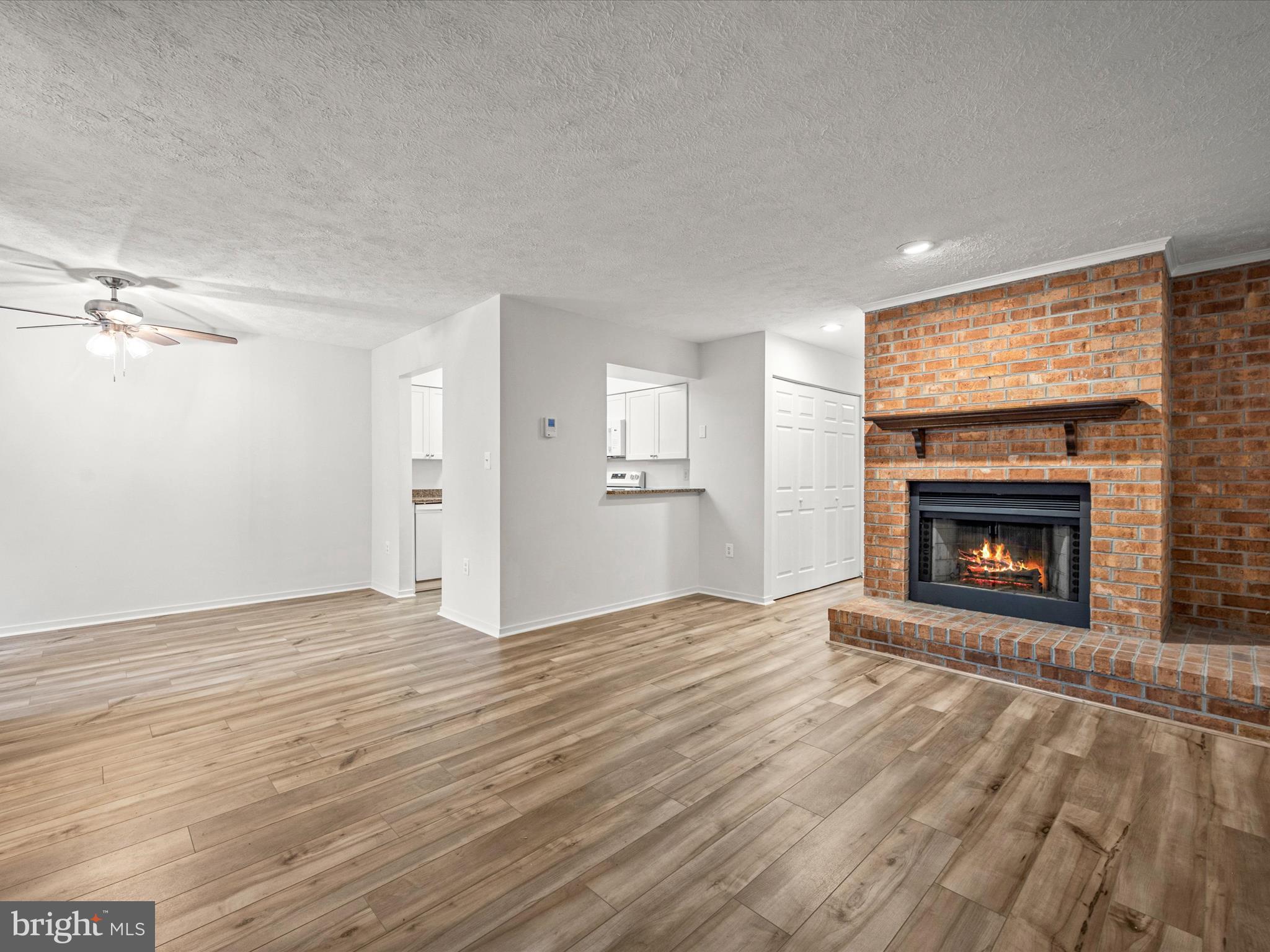 7607 Weather Worn Way, Unit A Columbia, MD 21046 - Photo 9 of 36 a view of an empty room with a fireplace and a window