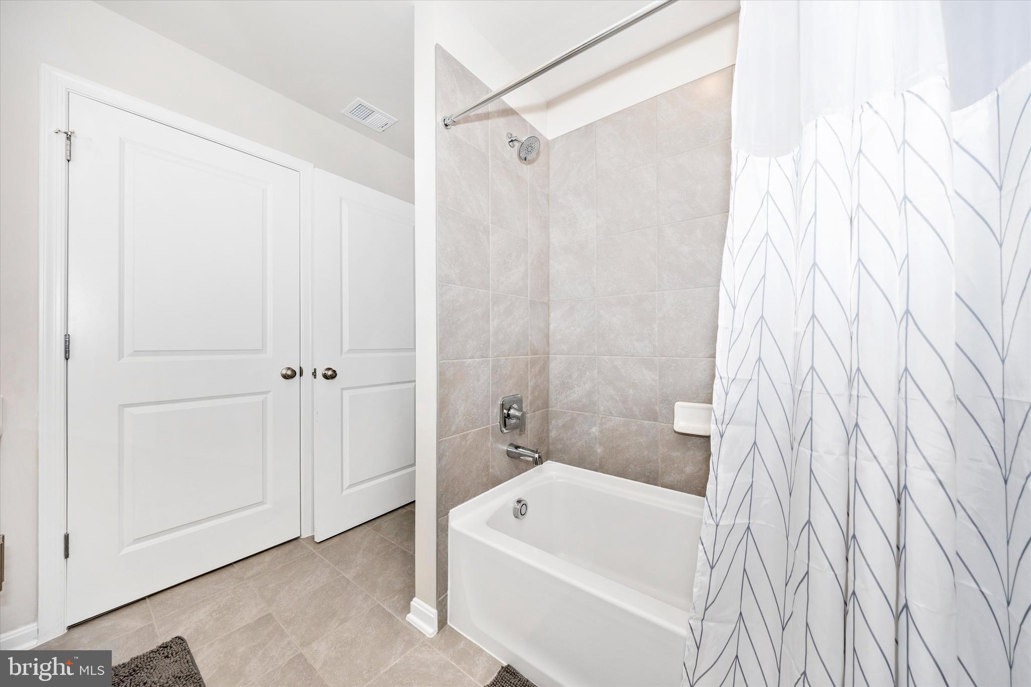 700 Bond Street Frederick, MD 21701 - Photo 27 of 49 a bathroom with a white bath tub