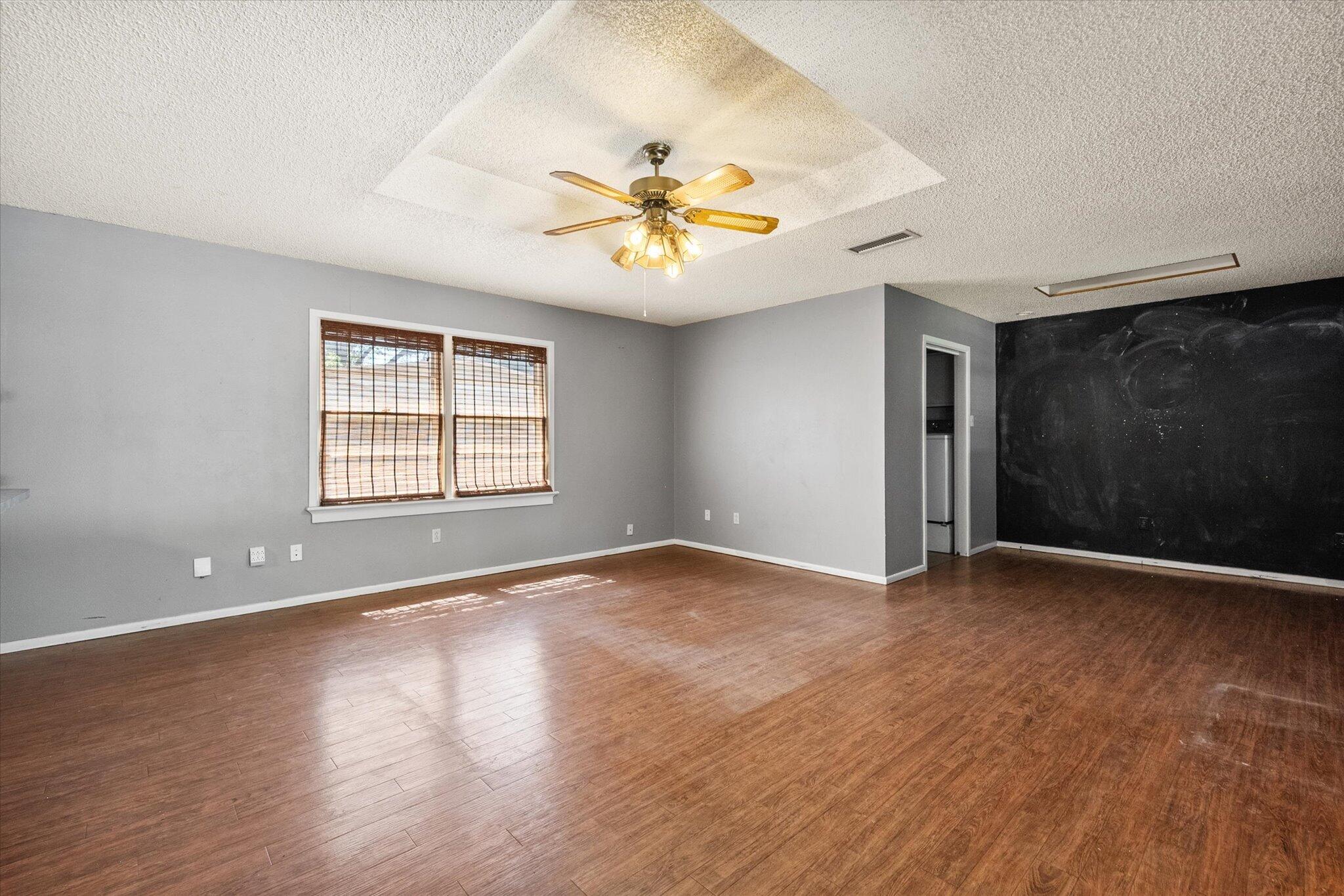 4604 27th Street Lubbock, TX 79410 - Photo 29 of 36 wooden floor in an empty room with a window