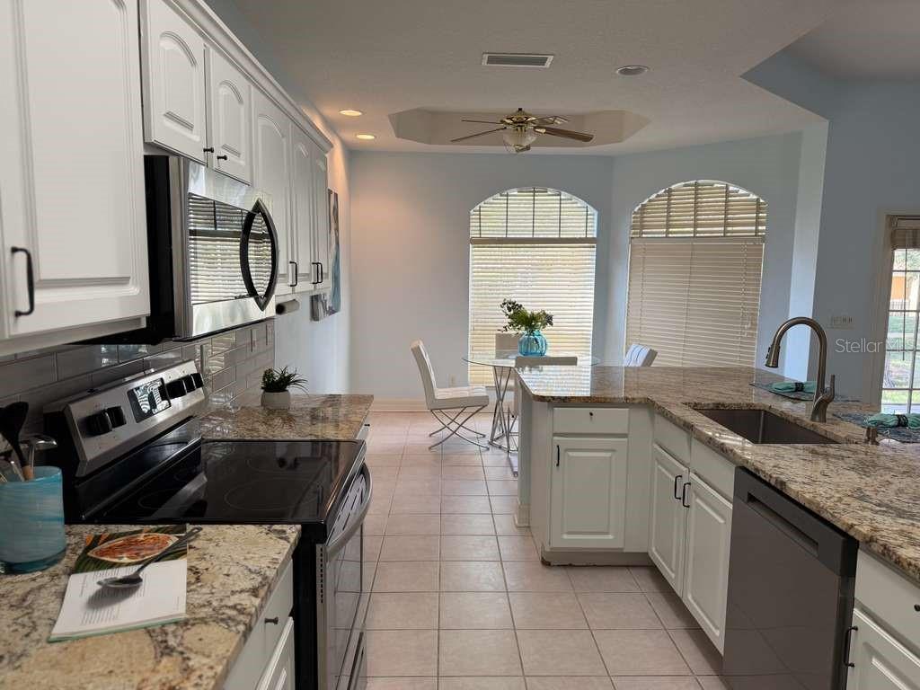 13606 Eagles Walk Drive Clearwater, FL 33762 - Photo 19 of 28 a kitchen with a sink appliances and cabinets