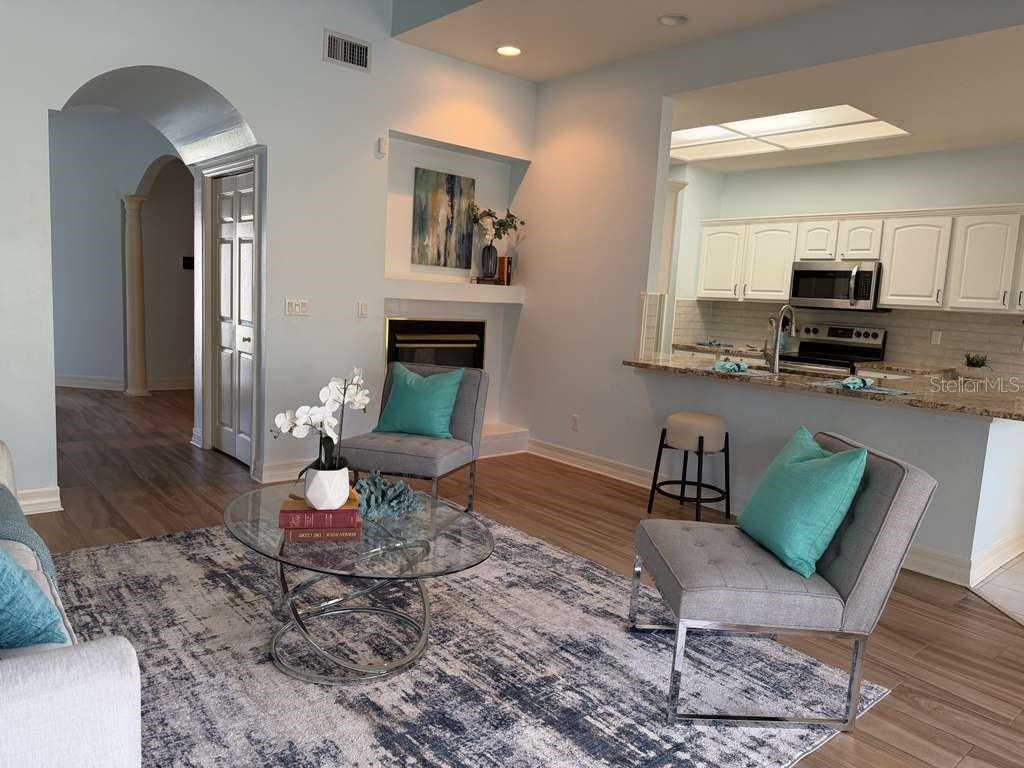 13606 Eagles Walk Drive Clearwater, FL 33762 - Photo 20 of 28 a living room with furniture a fireplace and a table