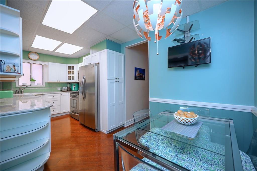 578 Ovington Avenue Brooklyn, NY 11209 - Photo 11 of 40 a kitchen with stainless steel appliances granite countertop a refrigerator and a stove