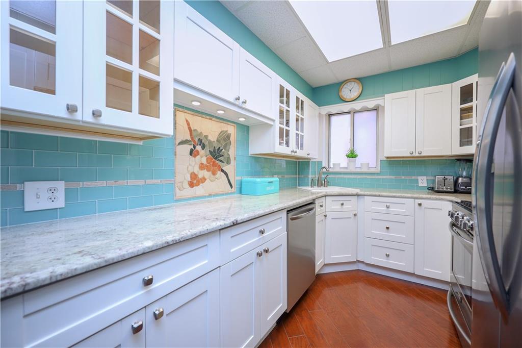 578 Ovington Avenue Brooklyn, NY 11209 - Photo 12 of 40 a kitchen with granite countertop white cabinets and white appliances