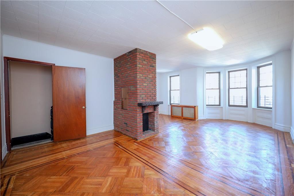 578 Ovington Avenue Brooklyn, NY 11209 - Photo 16 of 40 a view of an empty room with window and wooden floor