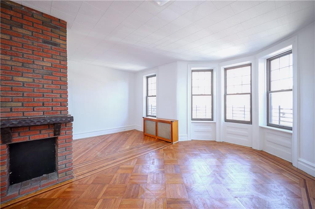 578 Ovington Avenue Brooklyn, NY 11209 - Photo 17 of 40 a view of an empty room with a fireplace and a window