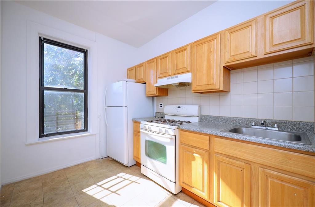578 Ovington Avenue Brooklyn, NY 11209 - Photo 19 of 40 a kitchen with stainless steel appliances granite countertop a stove a sink and a microwave
