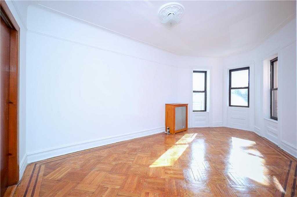 578 Ovington Avenue Brooklyn, NY 11209 - Photo 20 of 40 a view of a livingroom with wooden floor and window