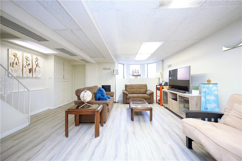 578 Ovington Avenue Brooklyn, NY 11209 - Photo 23 of 40 a living room with furniture and a flat screen tv