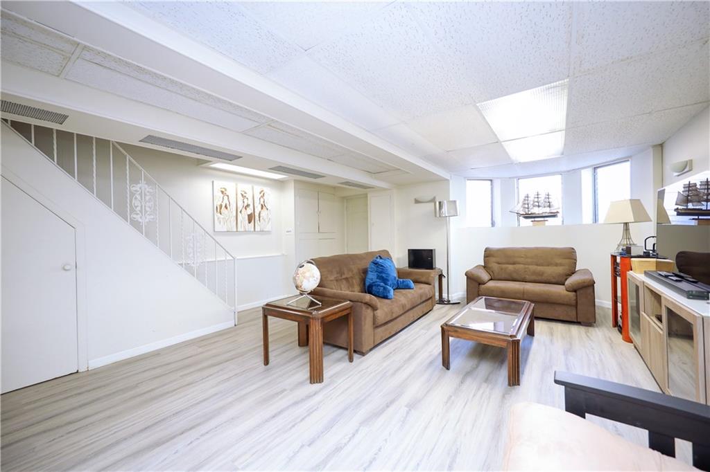 578 Ovington Avenue Brooklyn, NY 11209 - Photo 24 of 40 a living room with furniture and a wooden floor
