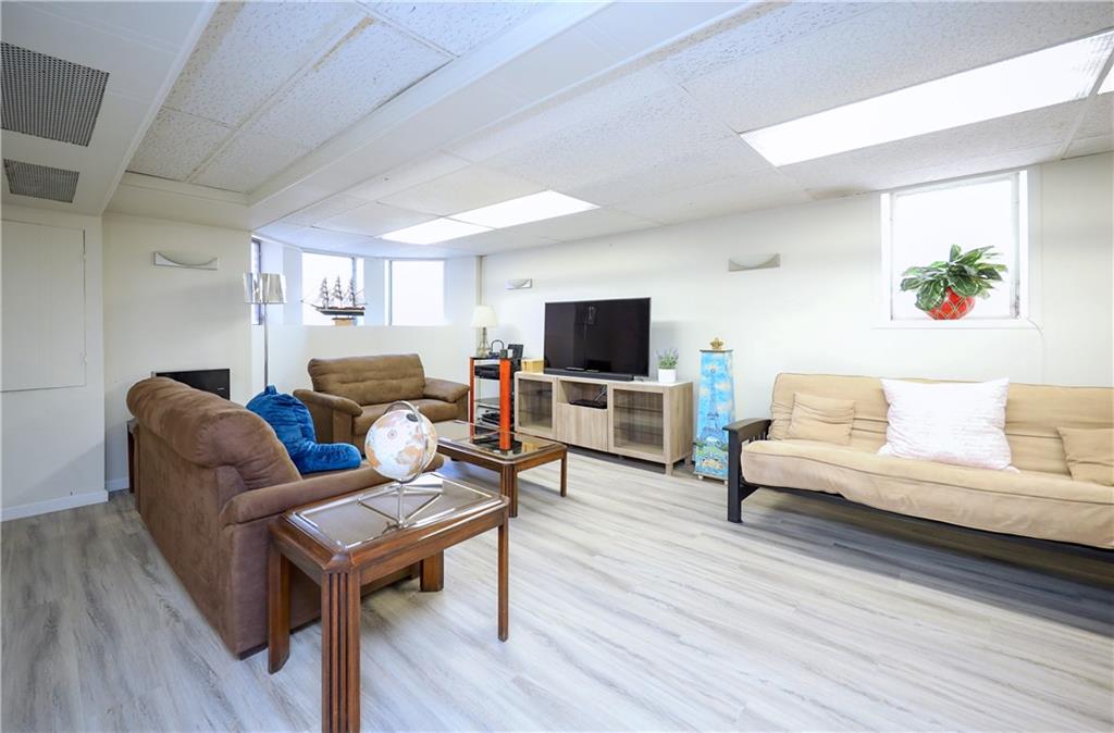 578 Ovington Avenue Brooklyn, NY 11209 - Photo 25 of 40 a living room with furniture a fireplace and a flat screen tv