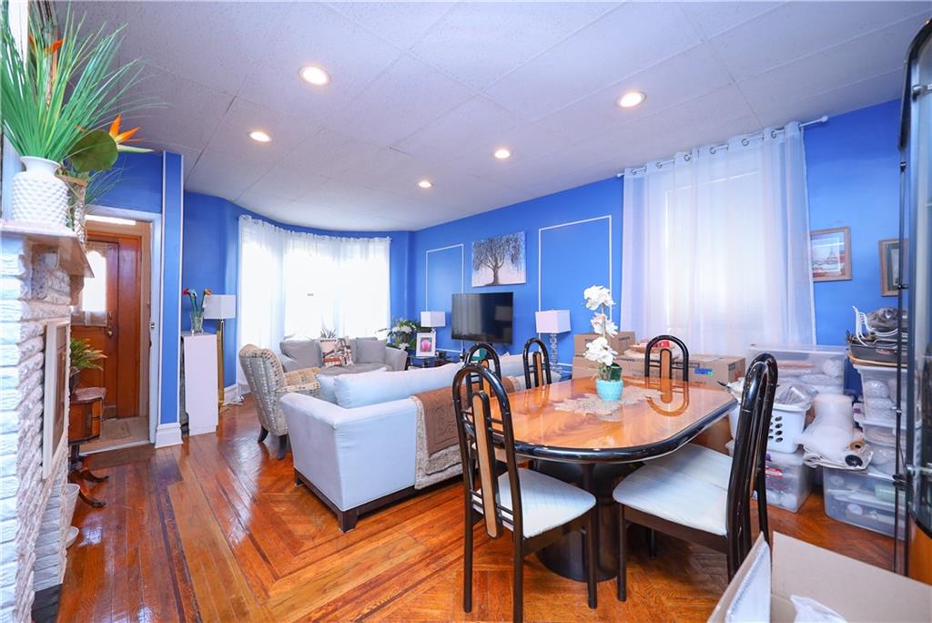 578 Ovington Avenue Brooklyn, NY 11209 - Photo 7 of 40 a living room with furniture a dining table and a refrigerator
