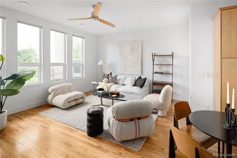 a living room with furniture and wooden floor
