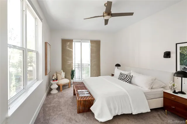 a spacious bedroom with a bed and a large window