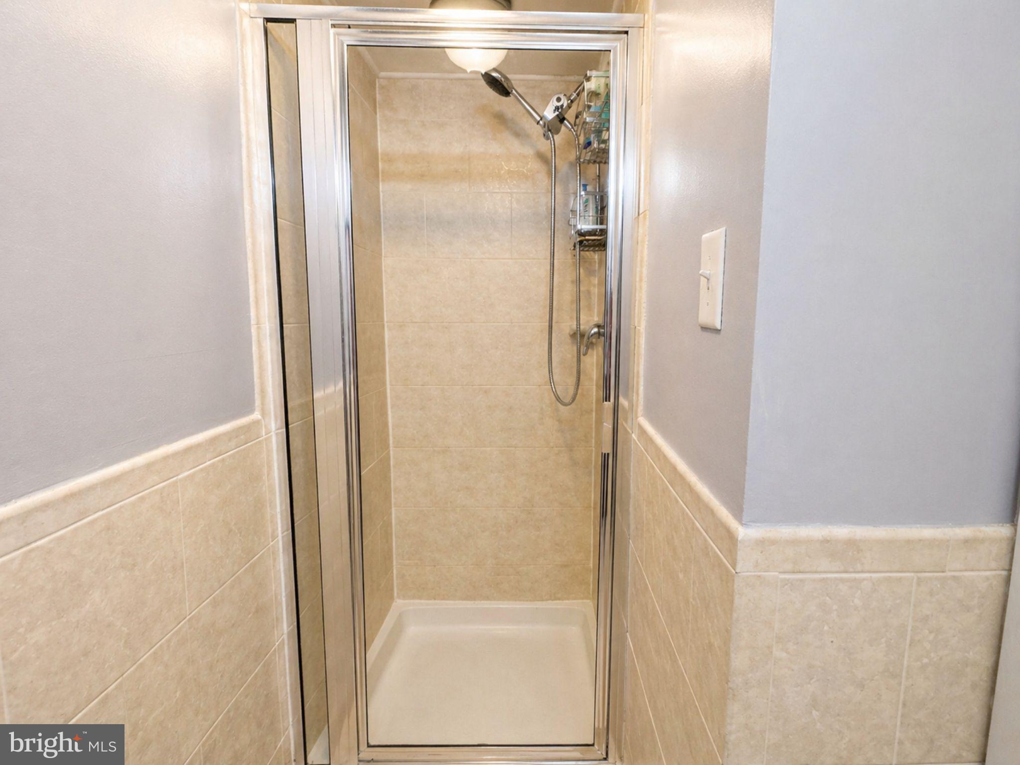 7 Rockford Road, Unit F1 Wilmington, DE 19806 - Photo 7 of 16 a bathroom with a glass shower door