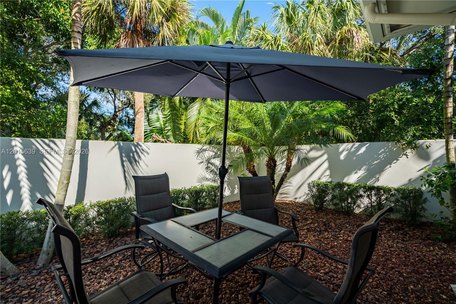 545 Southwest Indianola Street Stuart, FL 34994 - Photo 58 of 64 a view of an outdoor sitting area with furniture and a garden