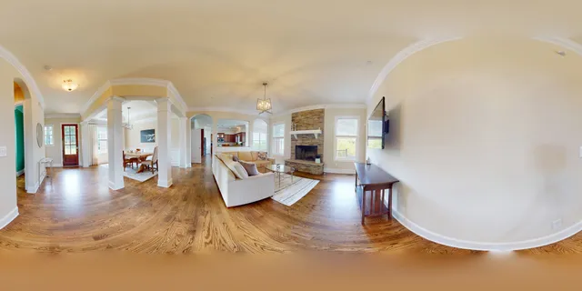 a spacious bedroom with a bed and a chandelier