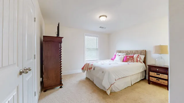 a view of a livingroom with a fireplace a window and a kitchen space
