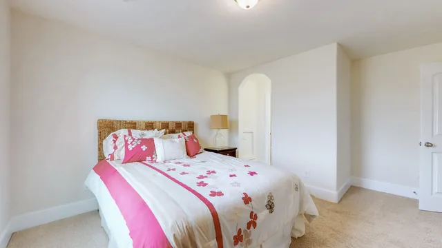a view of a livingroom with wooden floor a fireplace and entryway