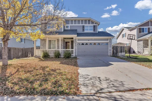 a front view of a house with a yard and a garage