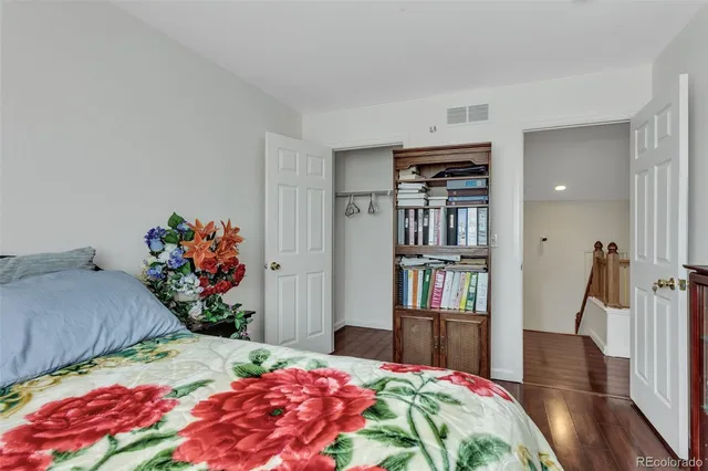 a bedroom with a bed furniture and a book shelf