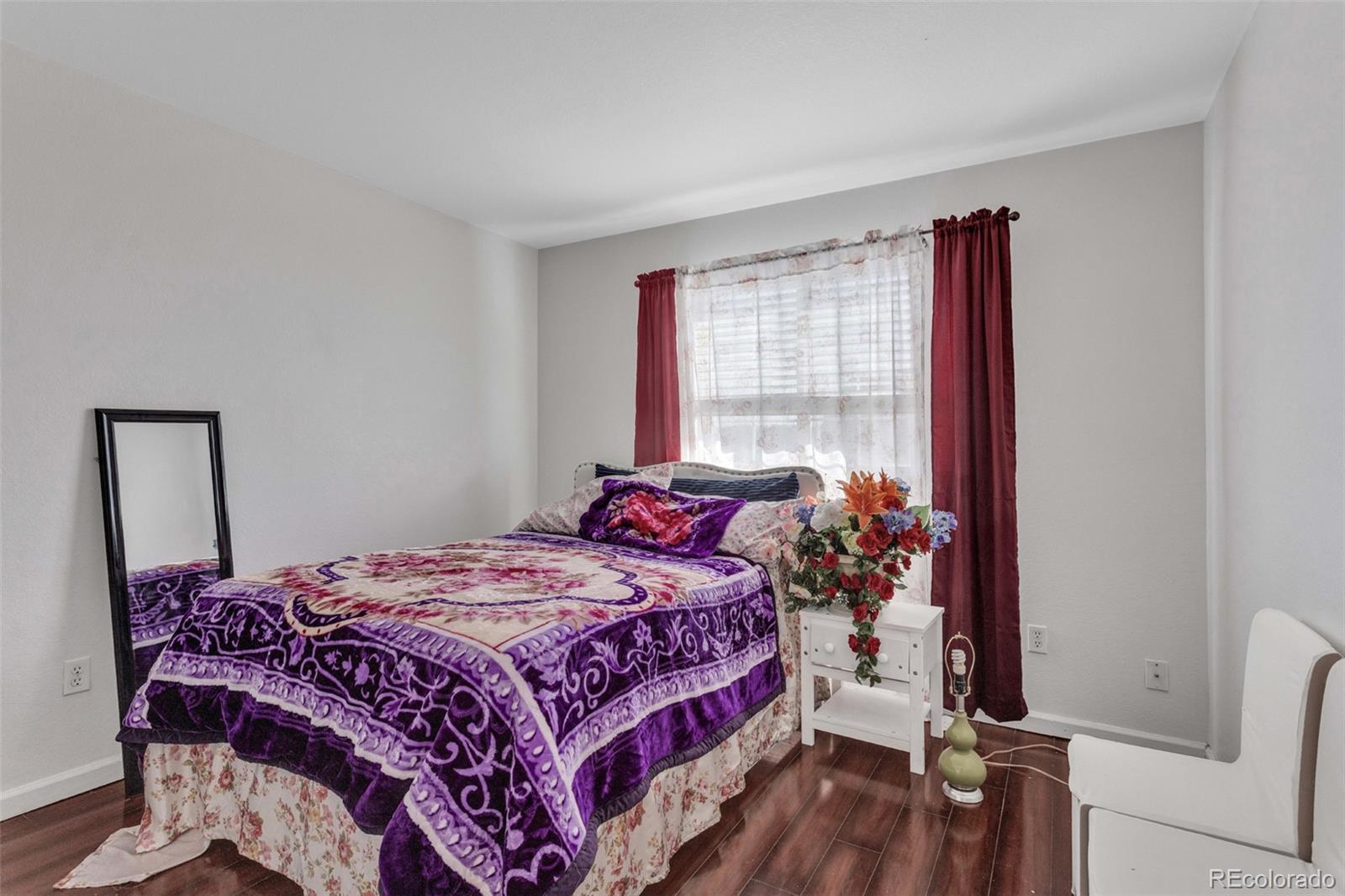 2645 South Danube Way Aurora, CO 80013 - Photo 14 of 24 a bedroom with a bed and a window