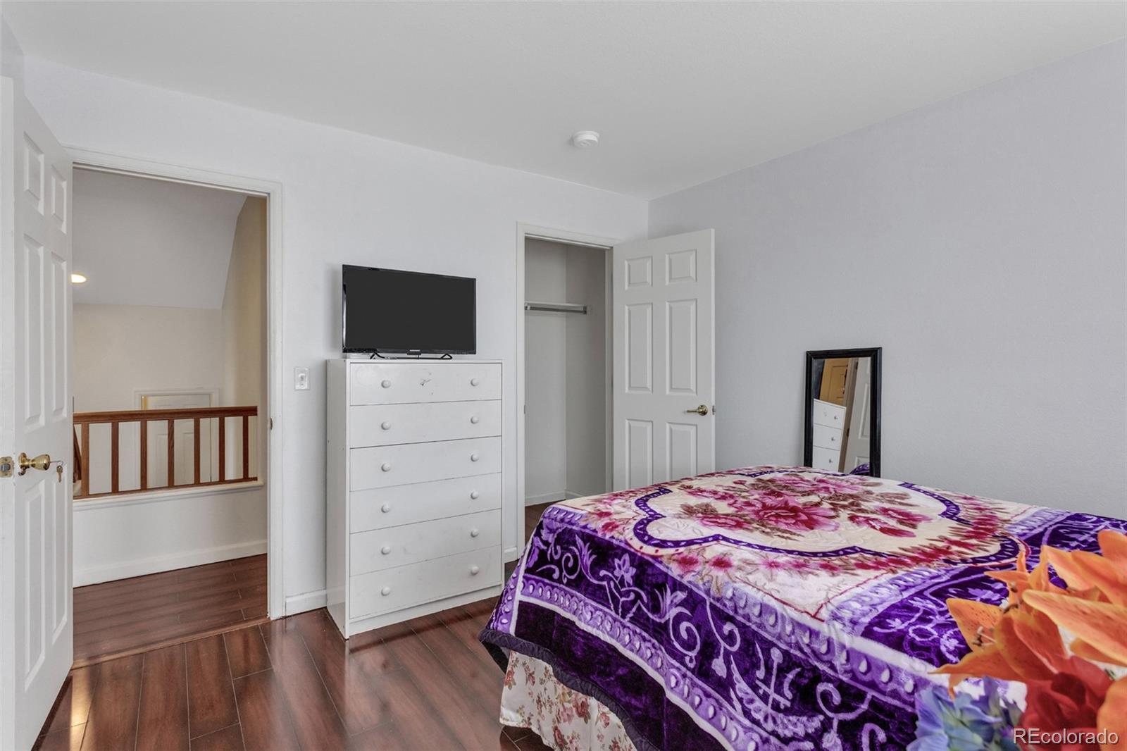 2645 South Danube Way Aurora, CO 80013 - Photo 15 of 24 a bedroom with a bed and a flat screen tv