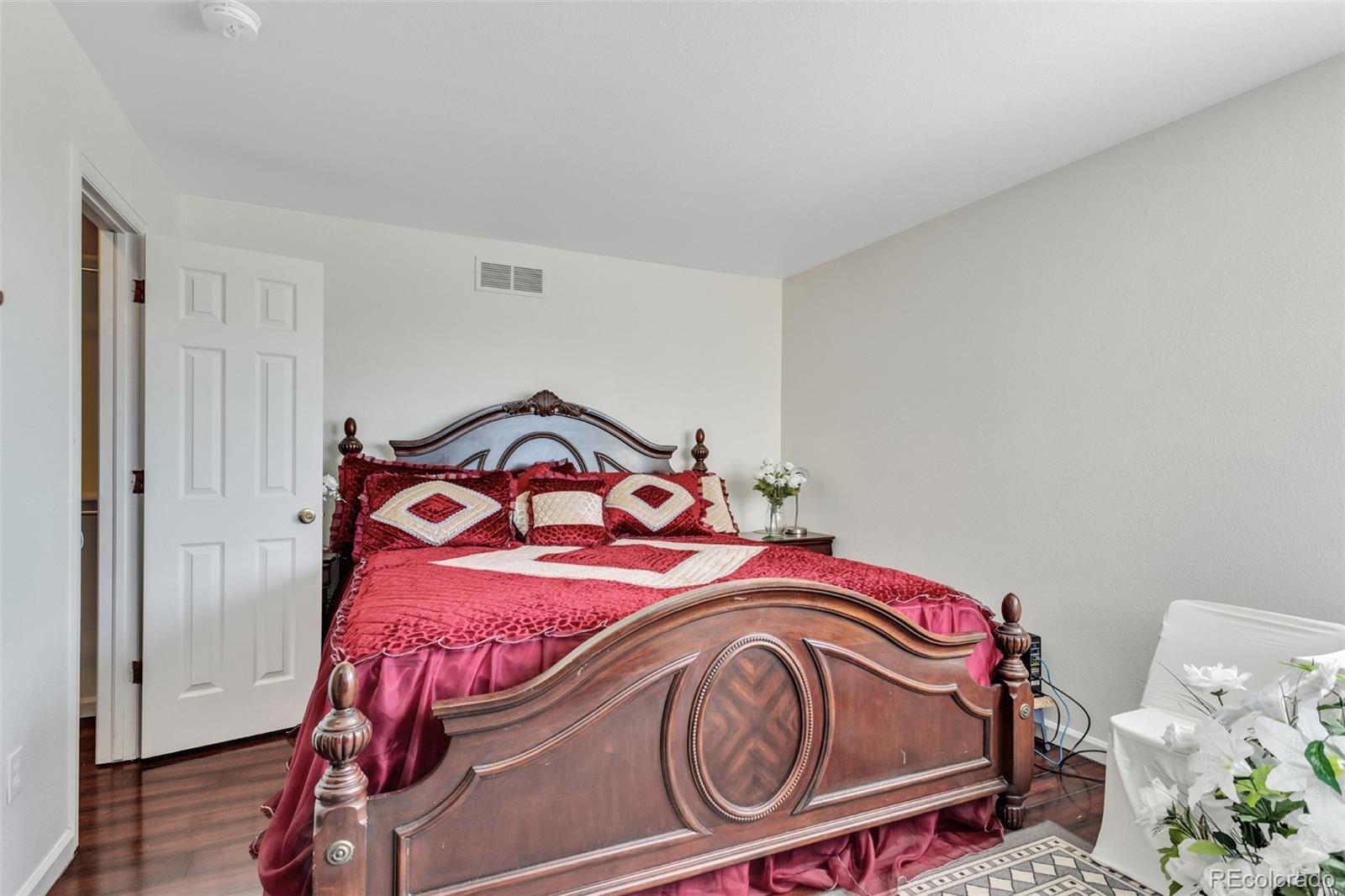 2645 South Danube Way Aurora, CO 80013 - Photo 18 of 24 a bedroom with a bed and a small bathroom