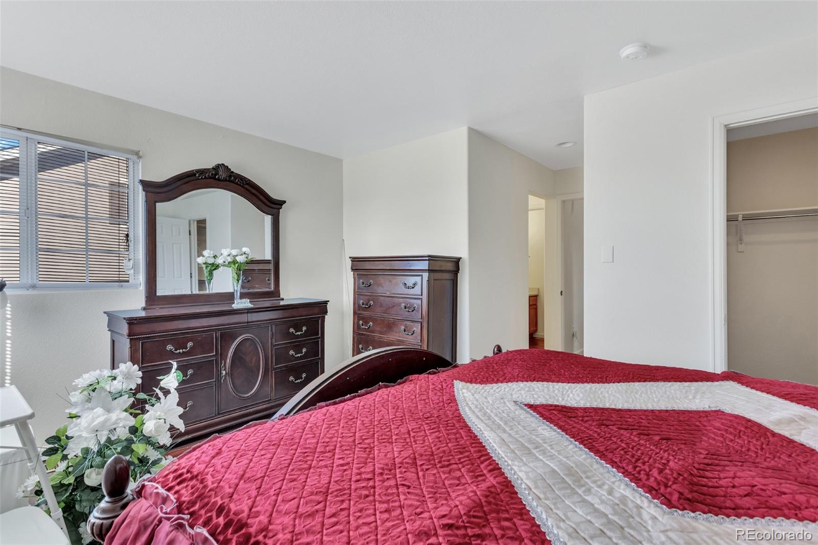 2645 South Danube Way Aurora, CO 80013 - Photo 19 of 24 a bedroom with a bed and a dresser