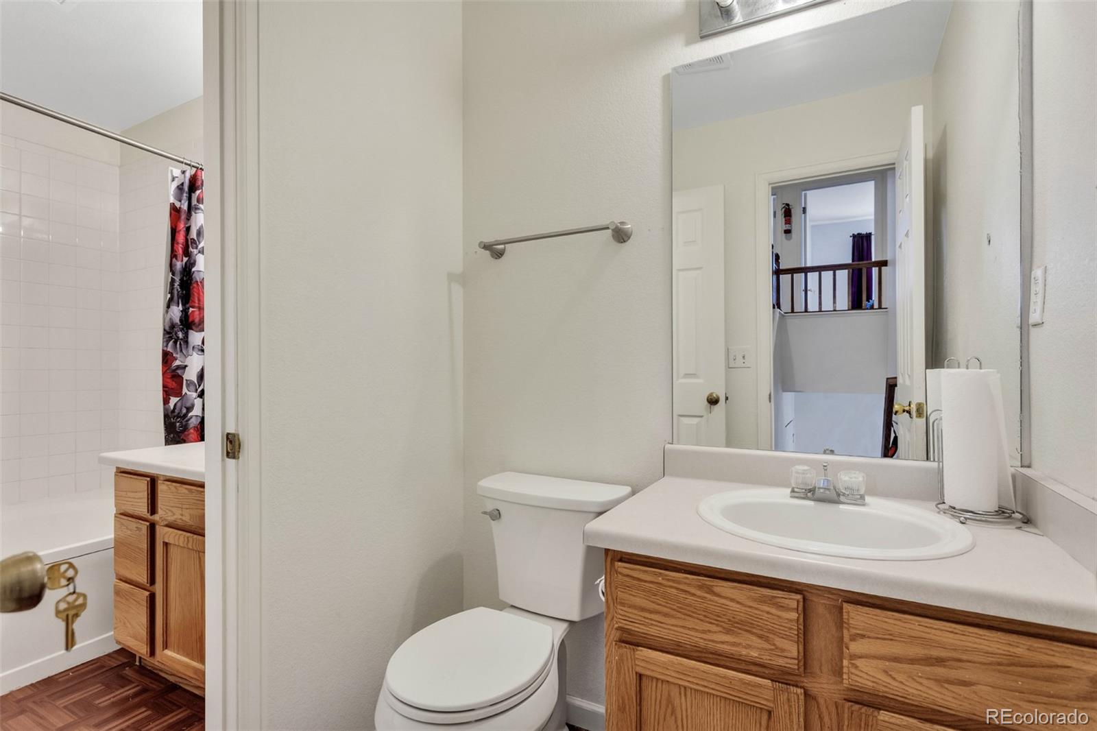 2645 South Danube Way Aurora, CO 80013 - Photo 22 of 24 a bathroom with a sink toilet and vanity
