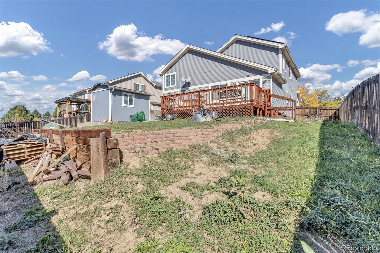 2645 South Danube Way Aurora, CO 80013 - Photo 23 of 24 a front view of a house with a yard
