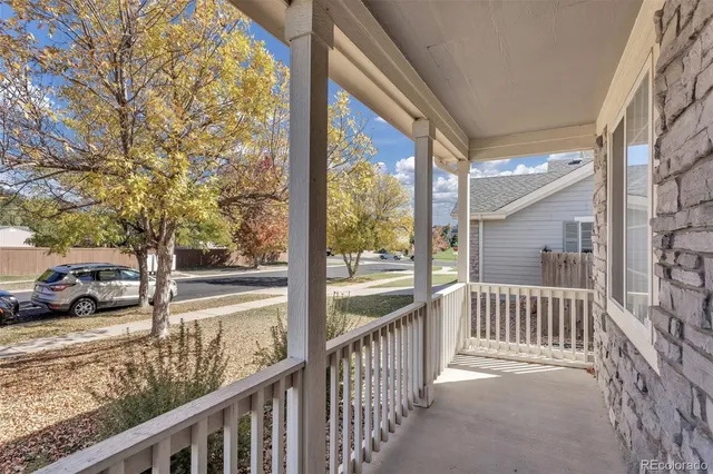 a view of a porch with wooden floor and fence