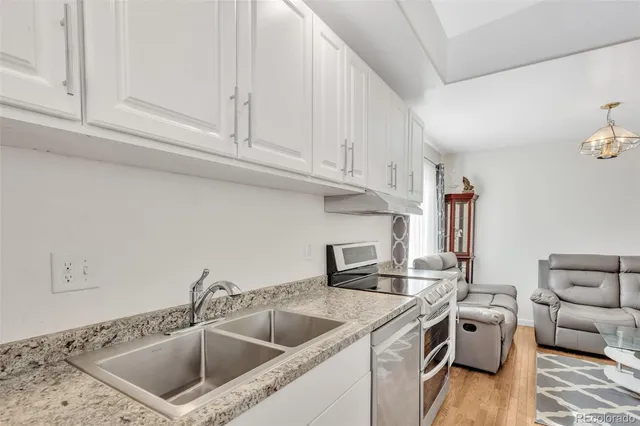 a kitchen with a sink cabinets and washer