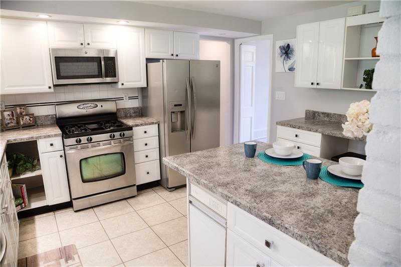 2323 Mill Grove Road Pittsburgh, PA 15241 - Photo 8 of 25 Gas stainless steele stove and other appliance with plenty of recessed lighting to brighten this kitchen.