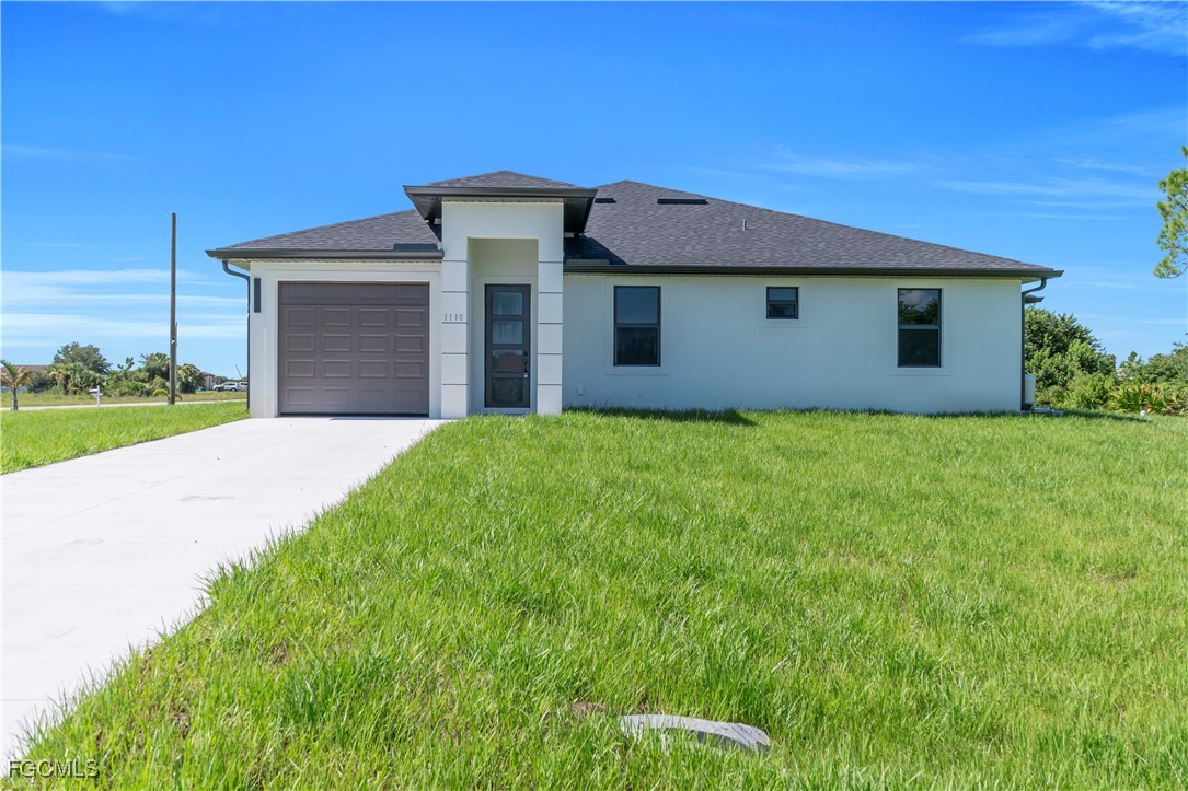 1112 Eisenhower Boulevard Lehigh Acres, FL 33974 - Photo 1 of 35 a view of a house with a yard