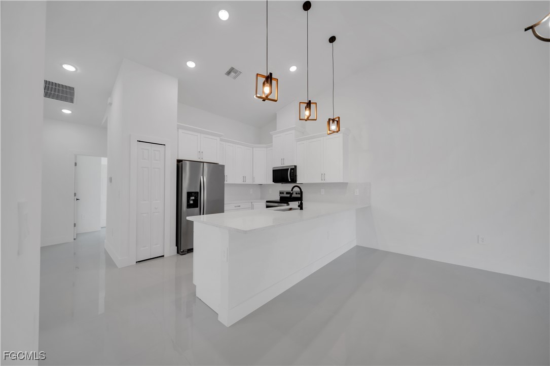1112 Eisenhower Boulevard Lehigh Acres, FL 33974 - Photo 17 of 35 a view of kitchen and living room