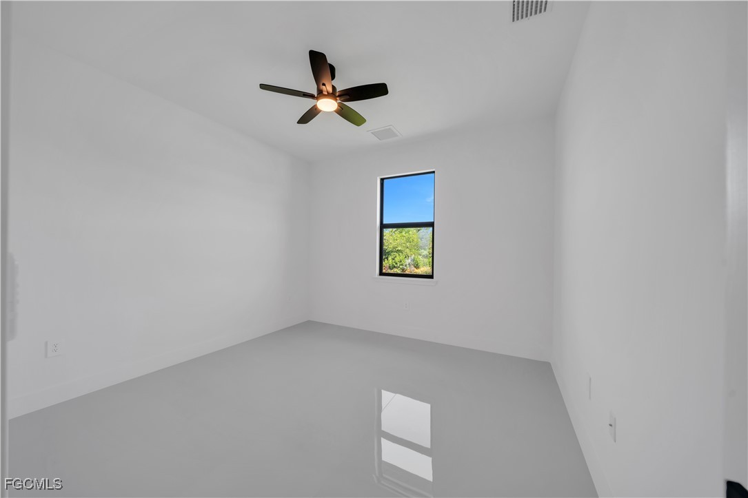 1112 Eisenhower Boulevard Lehigh Acres, FL 33974 - Photo 22 of 35 a view of a hallway with a window