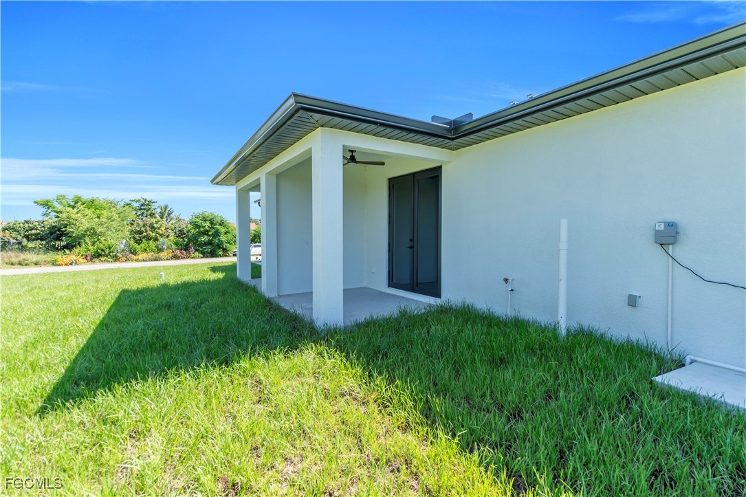 1112 Eisenhower Boulevard Lehigh Acres, FL 33974 - Photo 28 of 35 a view of a house with backyard and garden