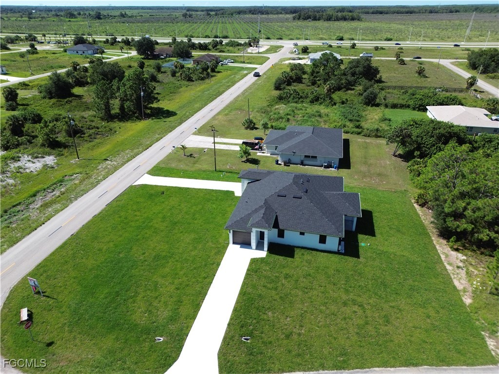1112 Eisenhower Boulevard Lehigh Acres, FL 33974 - Photo 33 of 35 an aerial view of a house with a garden