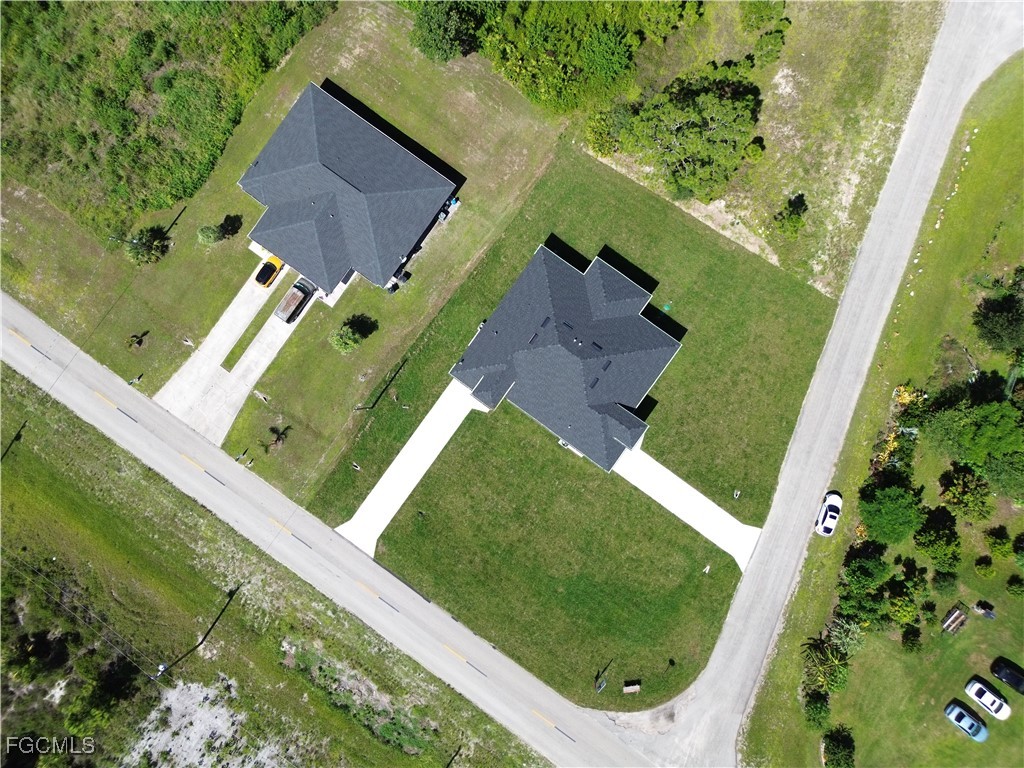 1112 Eisenhower Boulevard Lehigh Acres, FL 33974 - Photo 35 of 35 an aerial view of a residential house with a yard