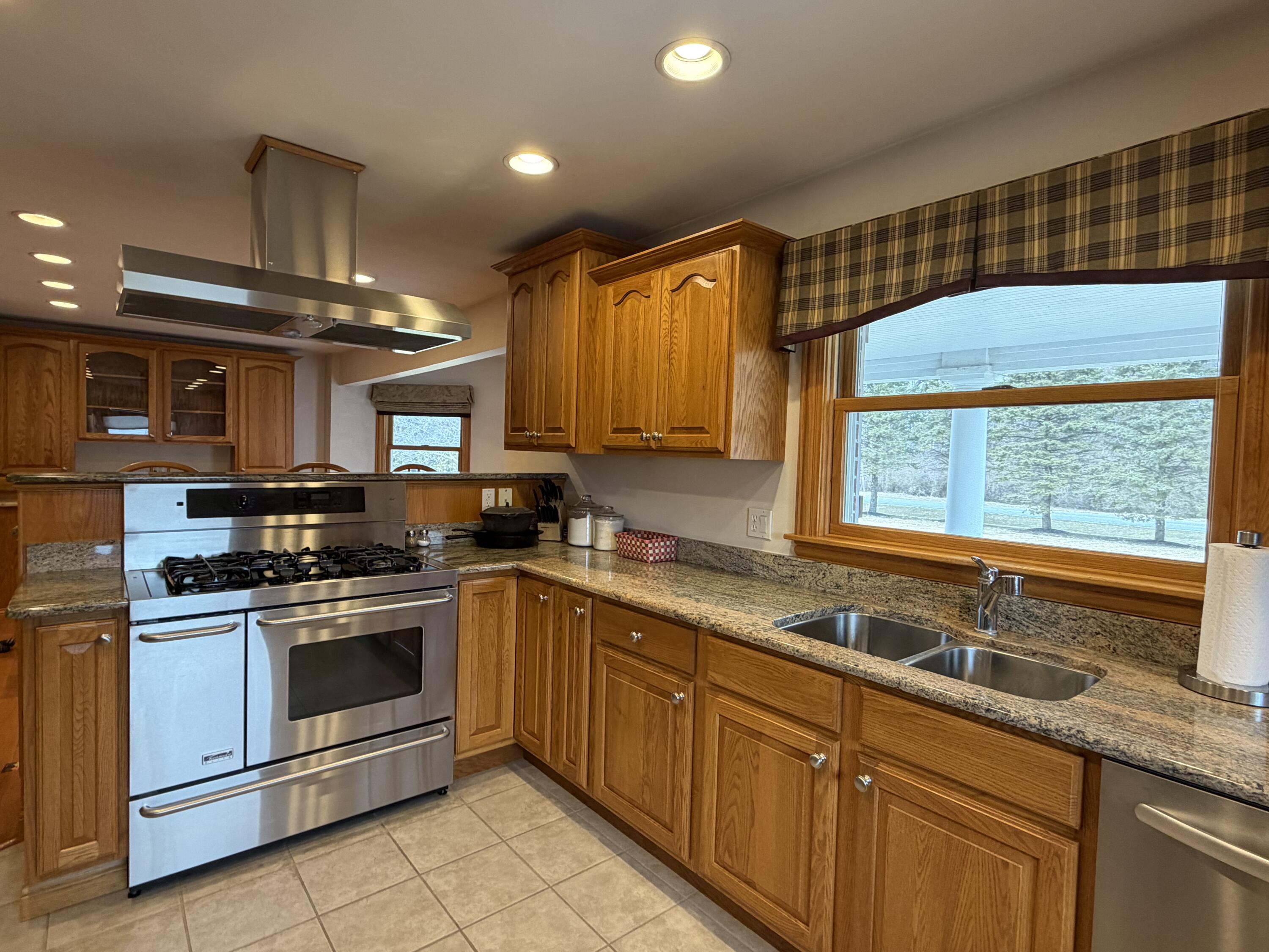 1245 West Mt Calvary Road Rensselaer, IN 47978 - Photo 12 of 35 a kitchen with stainless steel appliances wooden cabinets and a sink