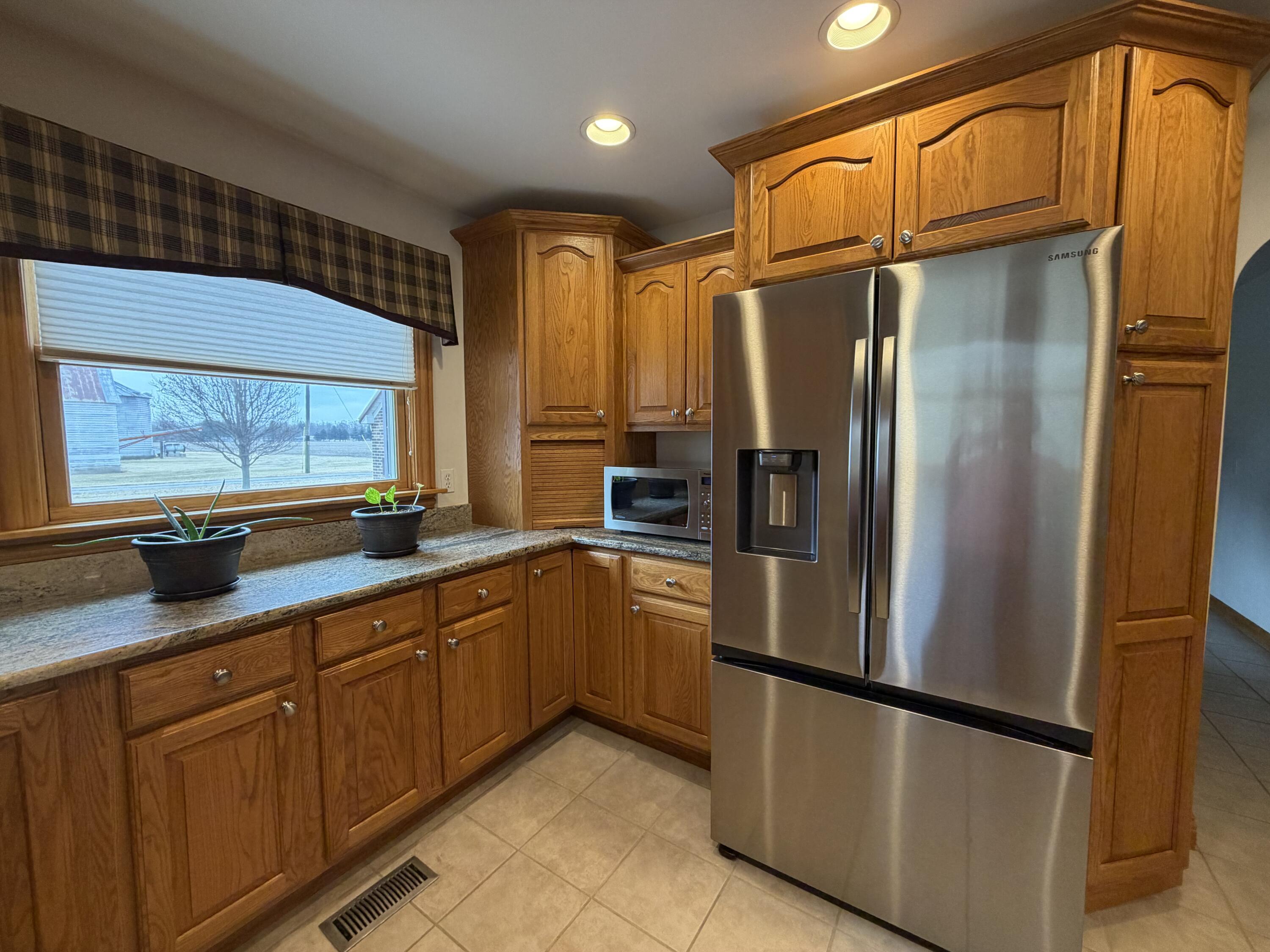 1245 West Mt Calvary Road Rensselaer, IN 47978 - Photo 14 of 35 a kitchen with stainless steel appliances a refrigerator and a sink