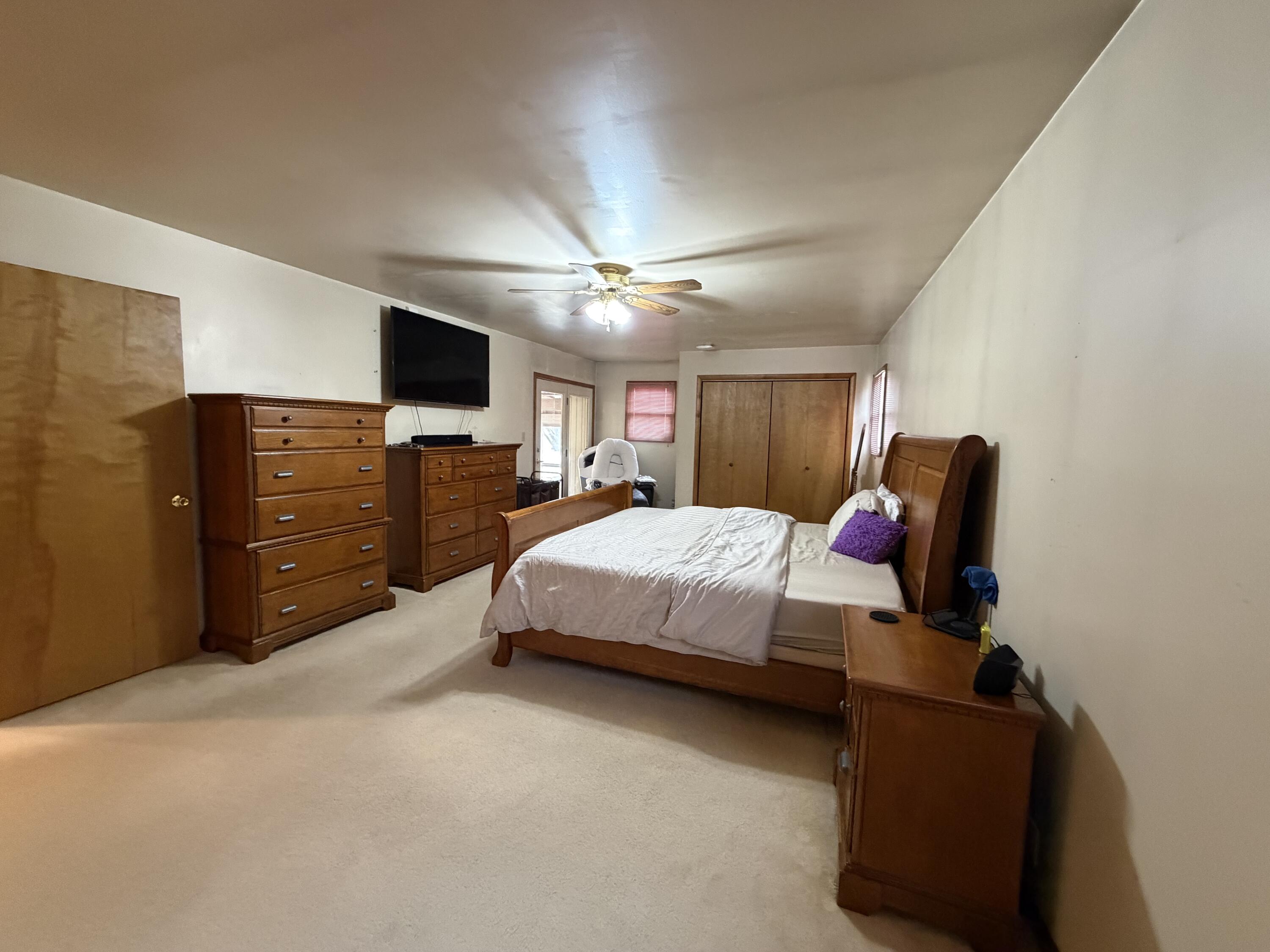 1245 West Mt Calvary Road Rensselaer, IN 47978 - Photo 16 of 35 a spacious bedroom with a bed and a flat screen tv