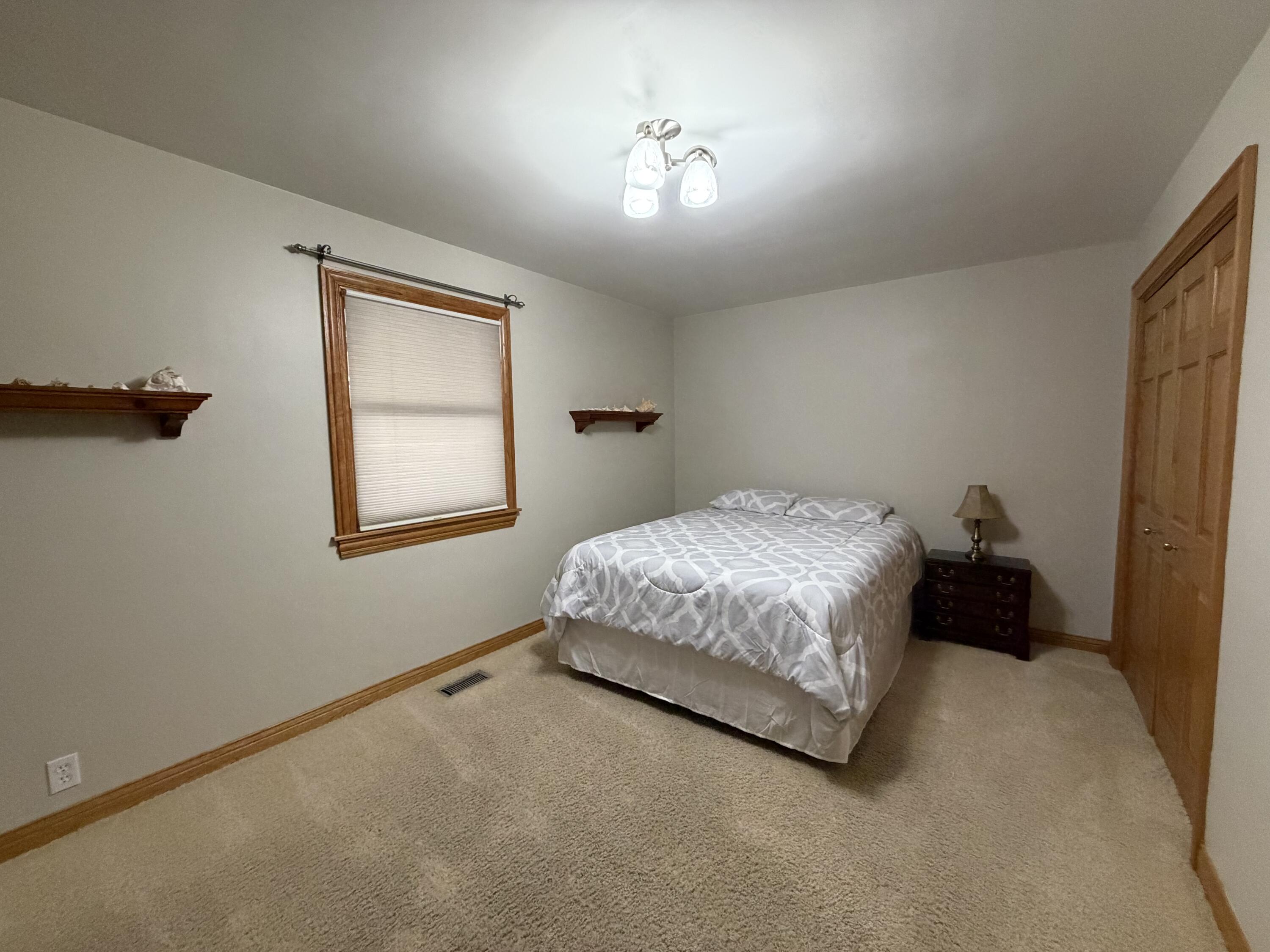 1245 West Mt Calvary Road Rensselaer, IN 47978 - Photo 20 of 35 a bedroom with a bed and a window