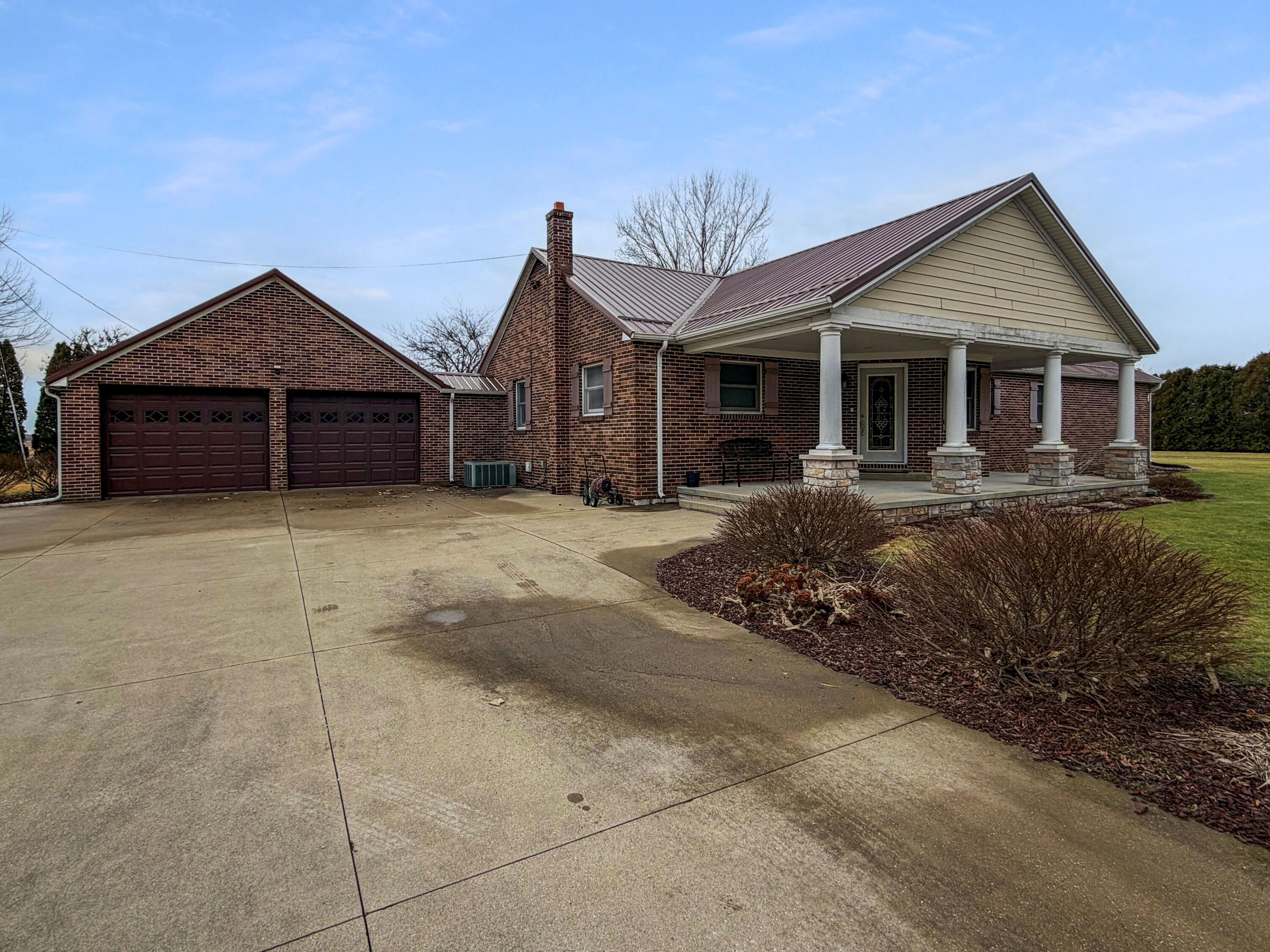 1245 West Mt Calvary Road Rensselaer, IN 47978 - Photo 2 of 35 a front view of a house with a garden