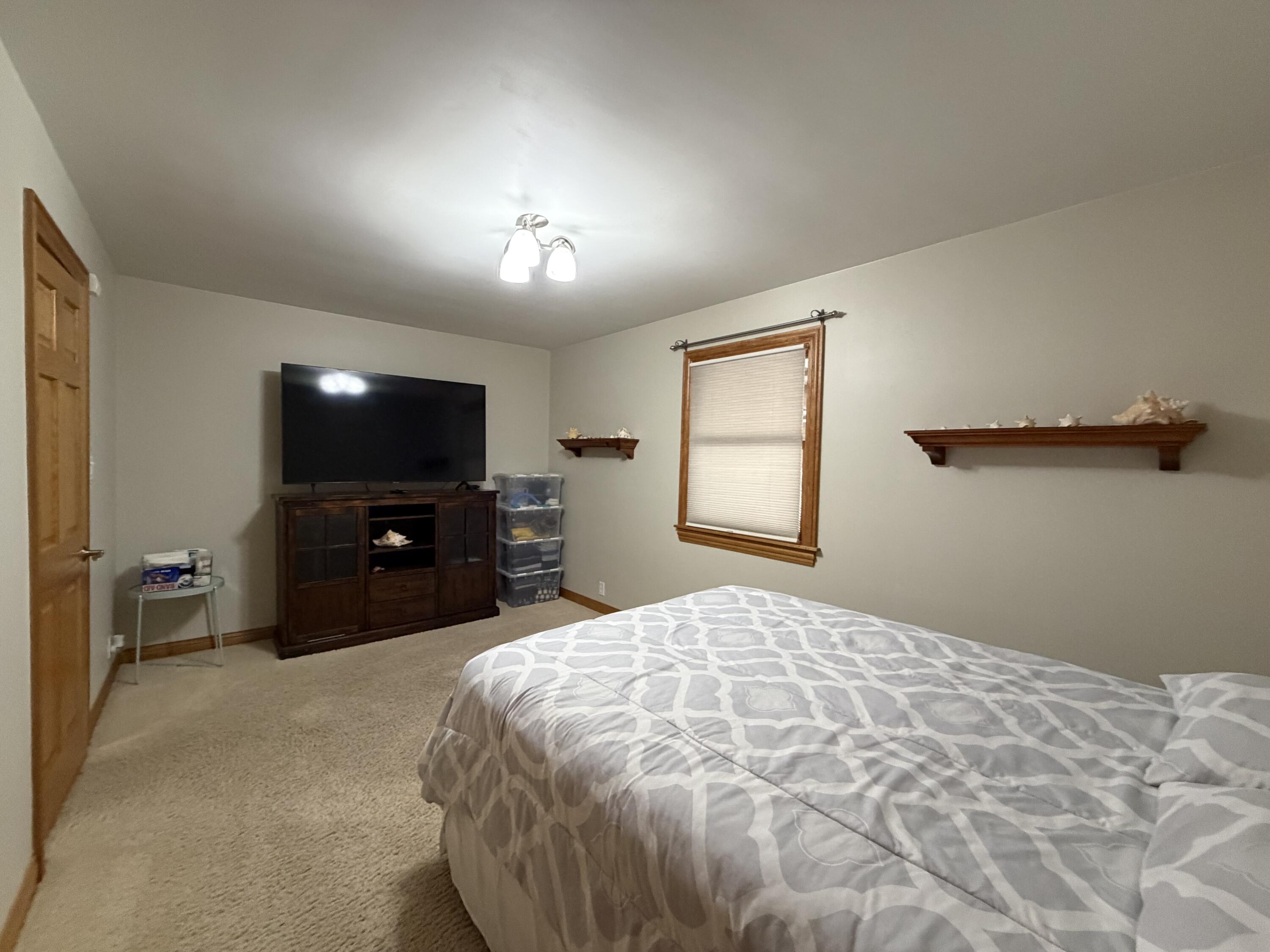 1245 West Mt Calvary Road Rensselaer, IN 47978 - Photo 21 of 35 a bedroom with a bed and a flat screen tv